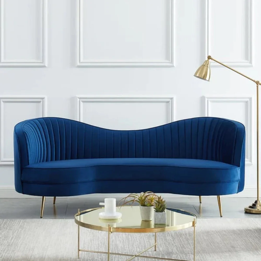 Upholstered Curved Sofa in blue suede velvet with a modern and elegant design in a living room